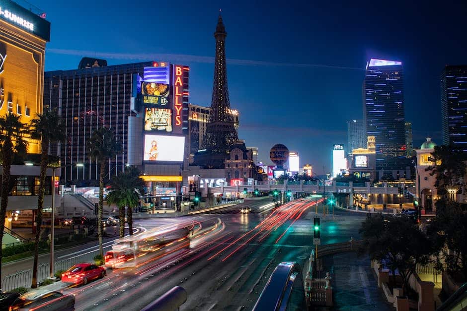 Las vegas at night with the eiffel tower in the background.