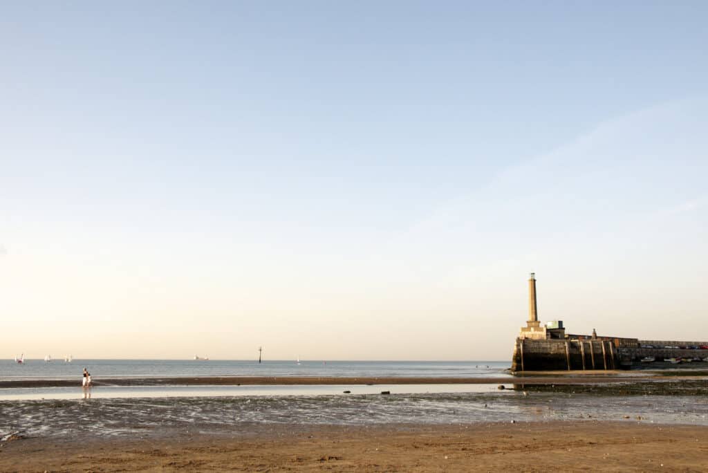 A person is flying a kite on the beach.