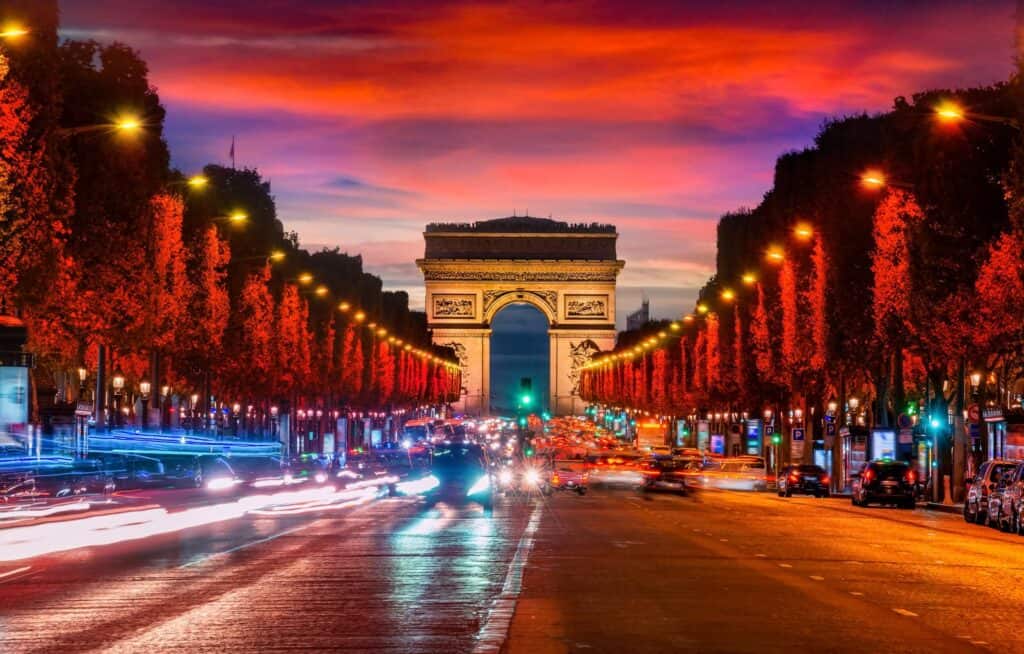 Paris at dusk: A guide to the nightlife scene in the city, featuring the Arc de Triomphe.