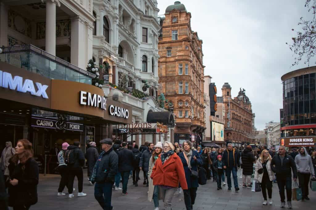 A crowd of people walking down a busy street in london.