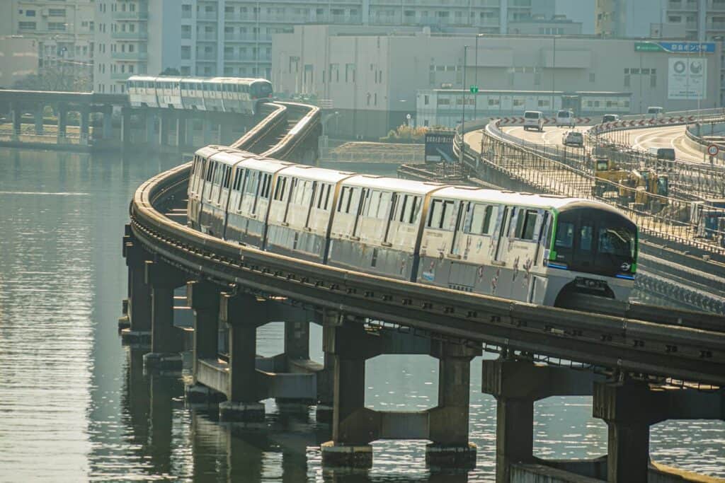 A train traveling on a bridge over a body of water.