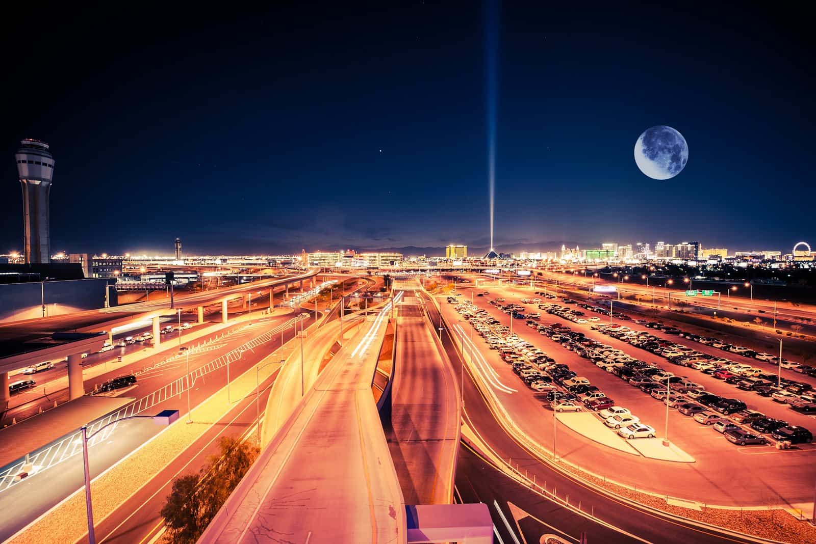 Las vegas skyline at night with a full moon.